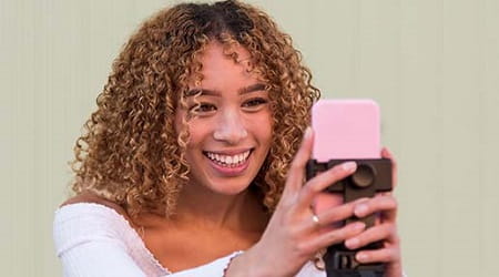 woman taking selfie with mobile phone