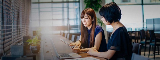 Two businesswomen on meeting using online data