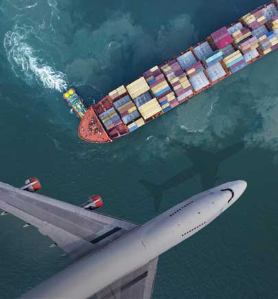 airplane flying over cargo ship in water